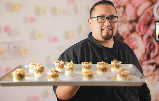 Chef holds tray of food at The Gardens of Sun City Assisted Living in Sun City, AZ