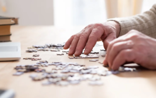 Senior male hands working on a puzzle